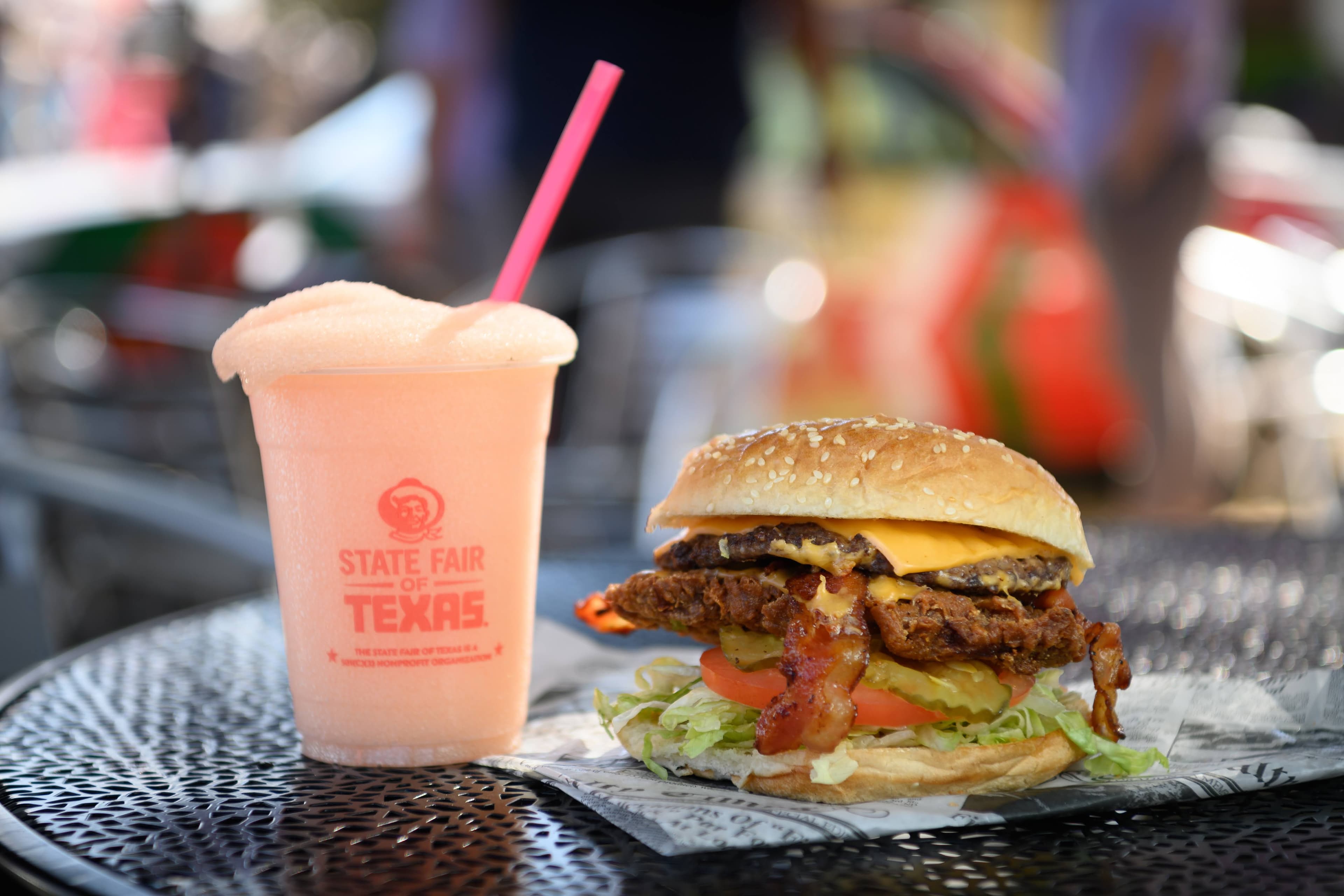 File photo: A burger and a pale pink drink sit on an outdoor table.